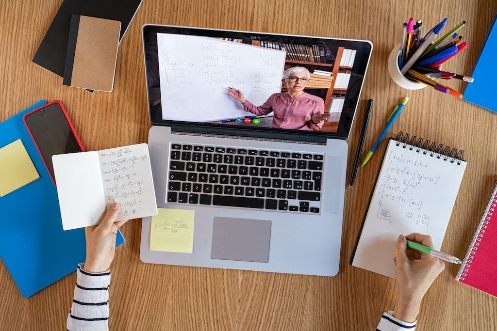 Top view of a laptop with a teacher teaching online with video conferencing