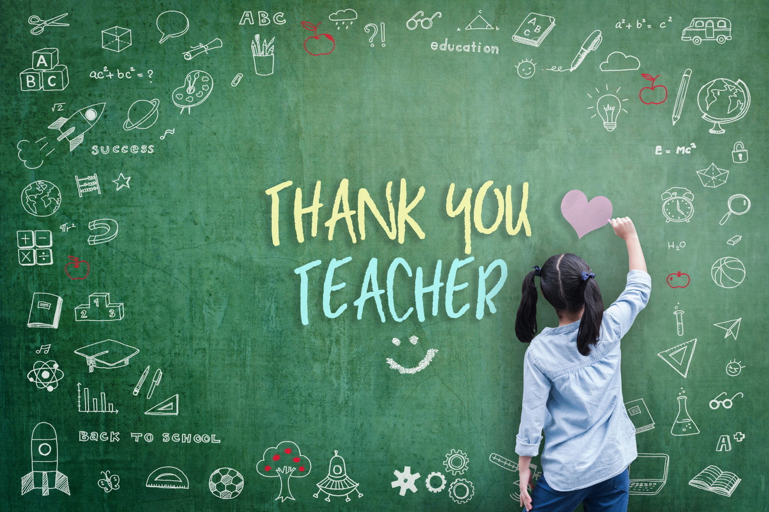 Girl writes on green board with chalks