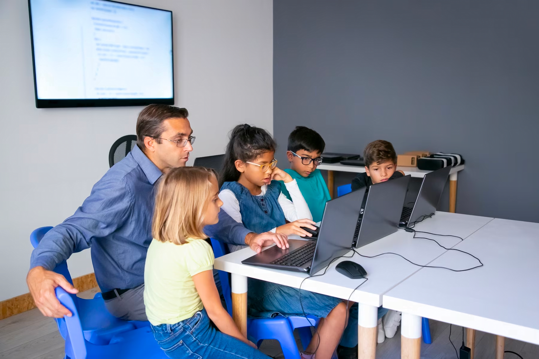 Teacher introducing technology to students as part of his classroom procedures