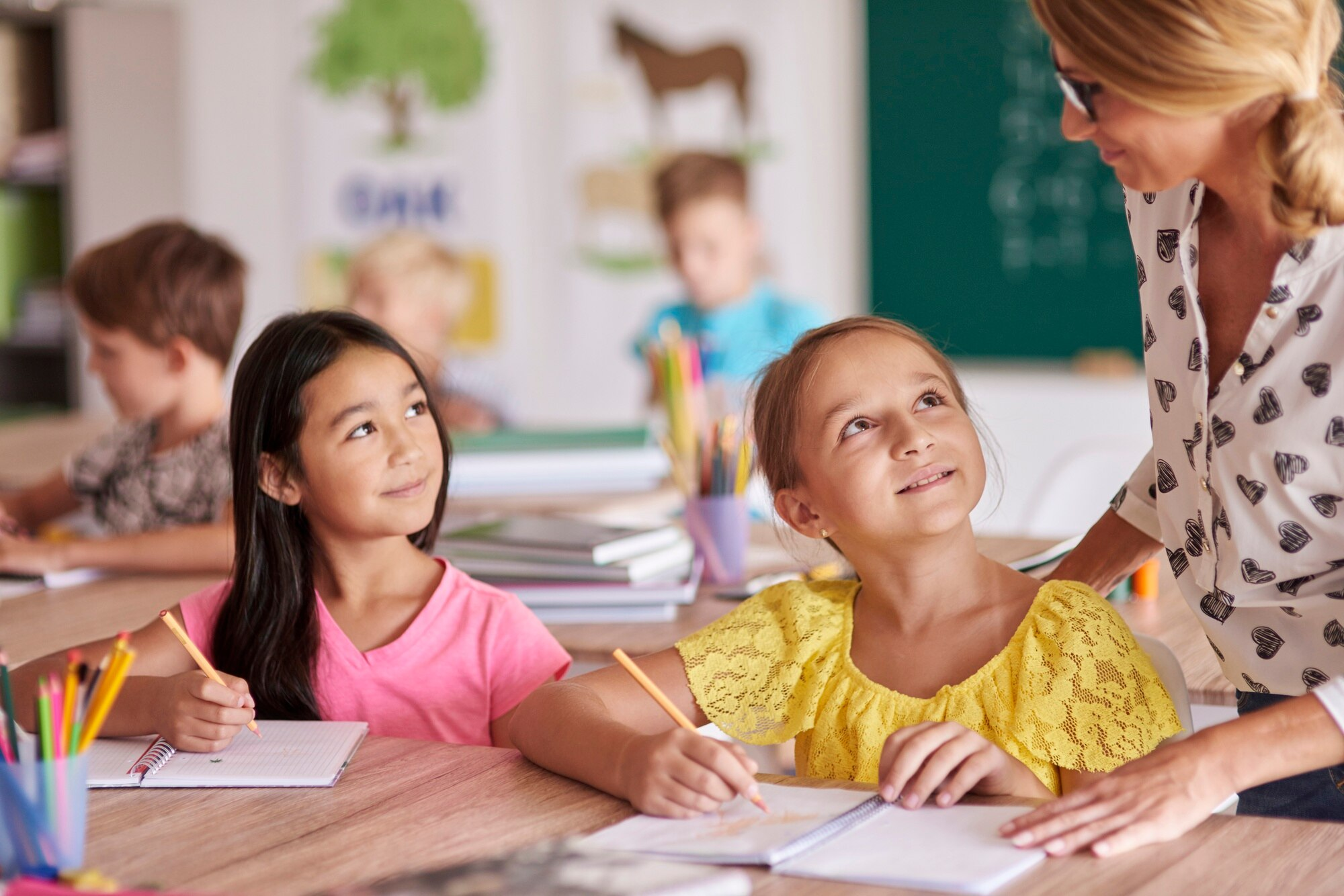 Teacher guiding students on school work