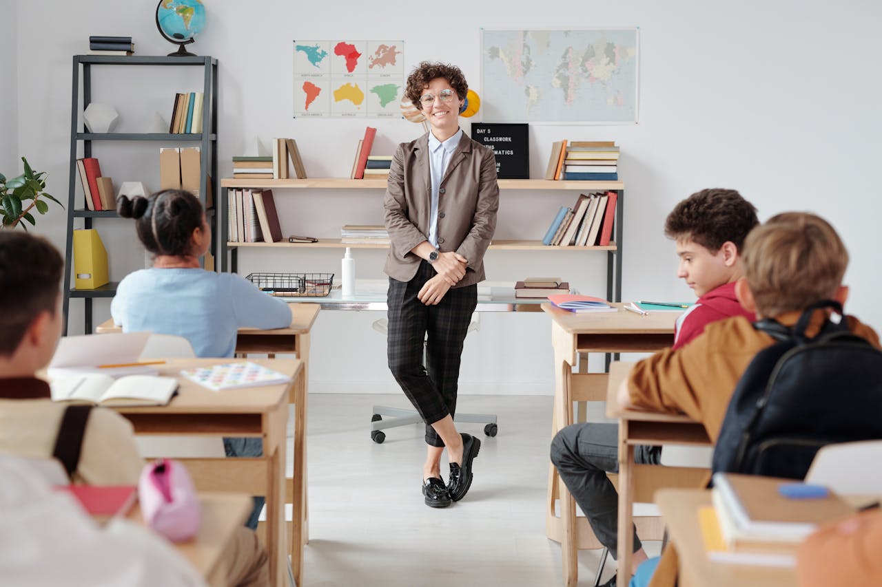 Teacher teaching in front of a class of students 